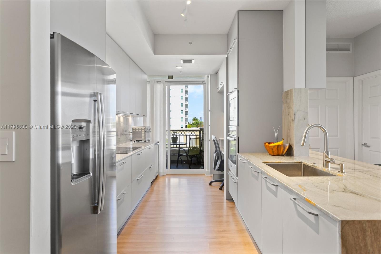 3232 Southwest 22nd Street, Unit 601 Miami, FL 33145 - Photo 8 of 38 a view of a kitchen with a sink and refrigerator