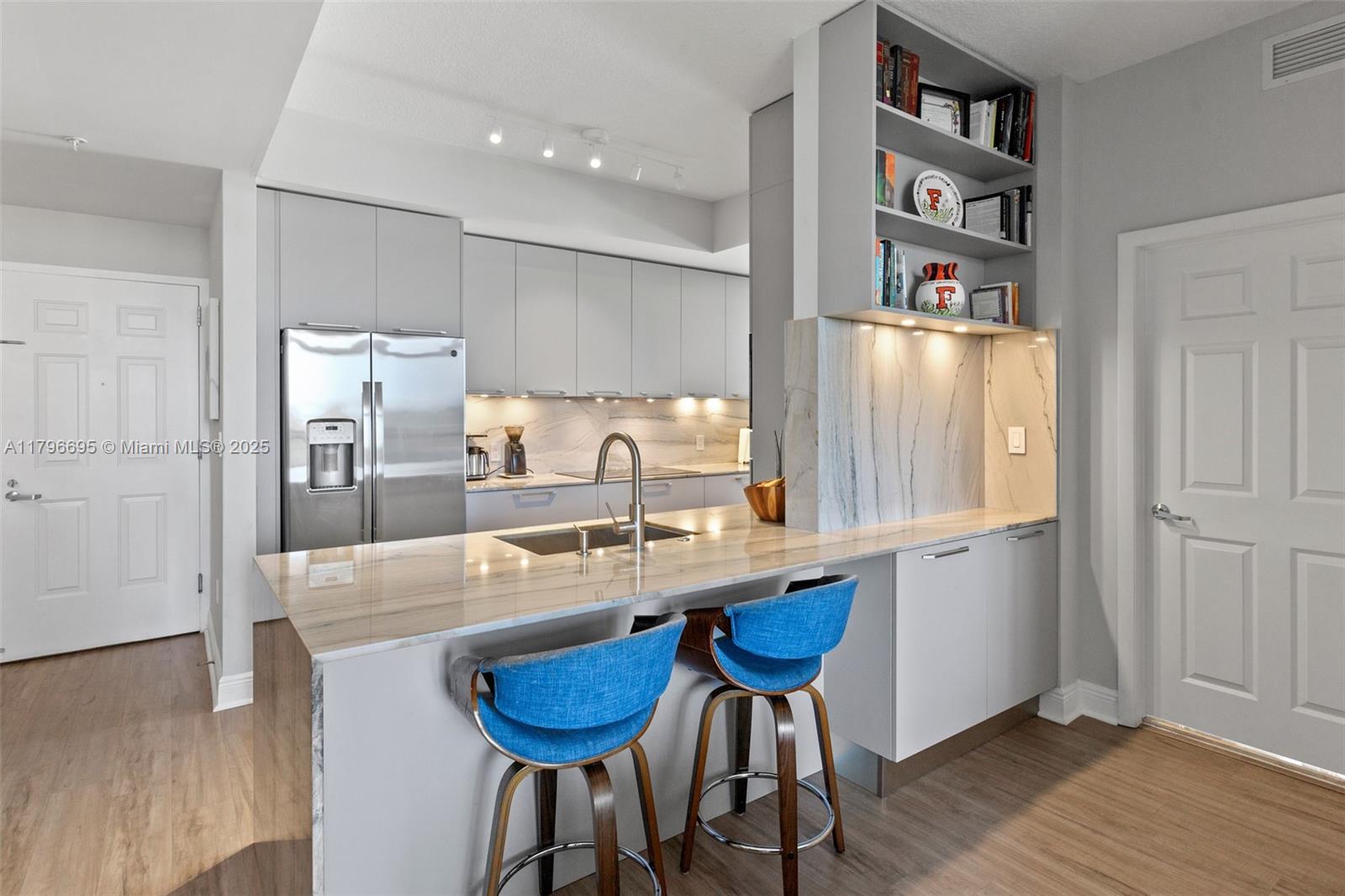 3232 Southwest 22nd Street, Unit 601 Miami, FL 33145 - Photo 9 of 38 a kitchen with stainless steel appliances a sink and a refrigerator
