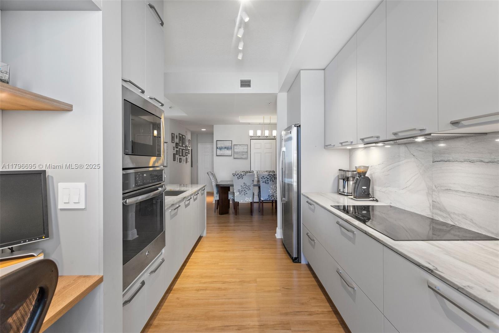 3232 Southwest 22nd Street, Unit 601 Miami, FL 33145 - Photo 10 of 38 a large kitchen with a large window and stainless steel appliances