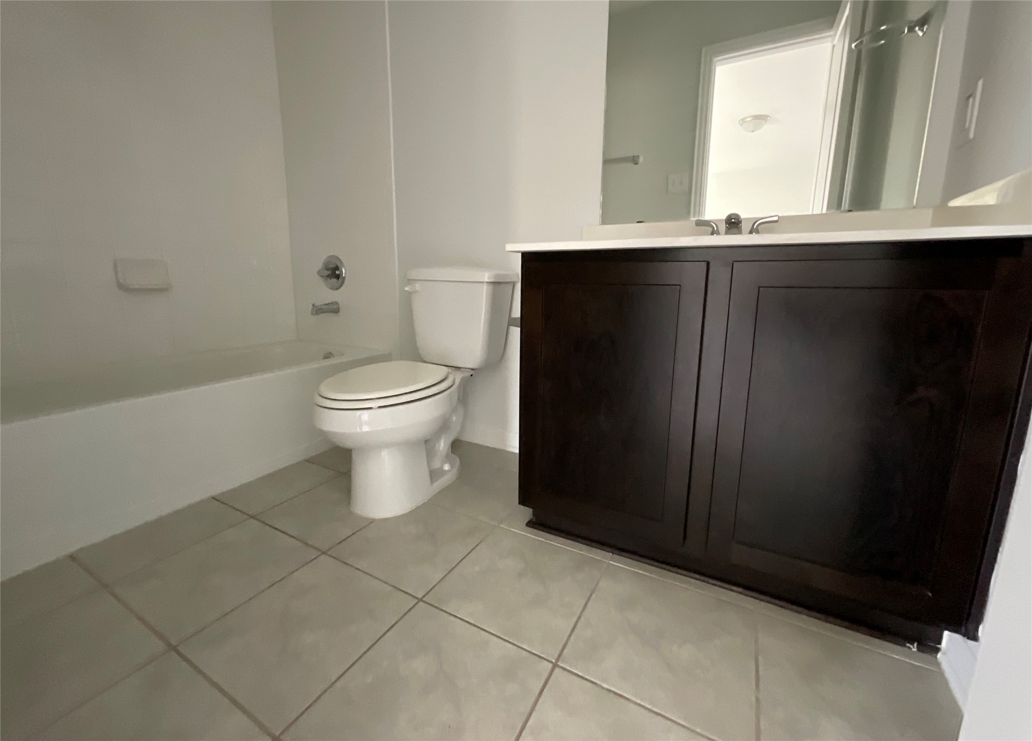8039 Brooks Crossing Drive Baytown, TX 77521 - Photo 13 of 24 a bathroom with a granite countertop toilet a sink and a mirror