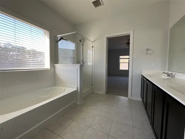 a bathroom with a bathtub and a sink