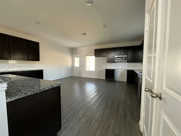 a kitchen with a refrigerator and a sink