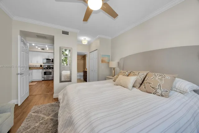 a bedroom with a large bed and a chandelier