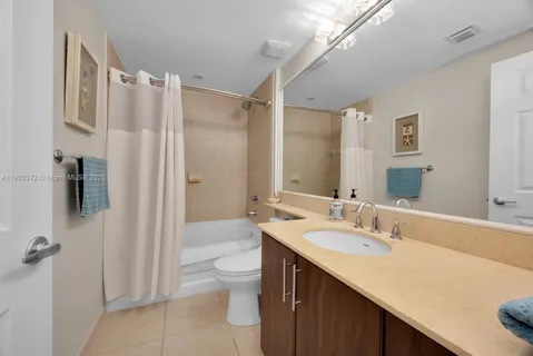 a bathroom with a double vanity sink toilet and shower