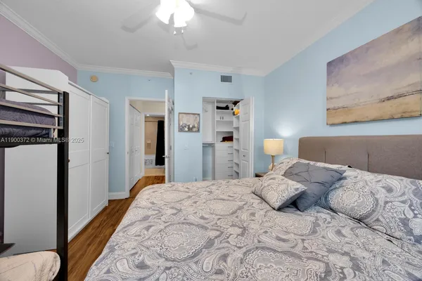 a bedroom with a bed and a chandelier
