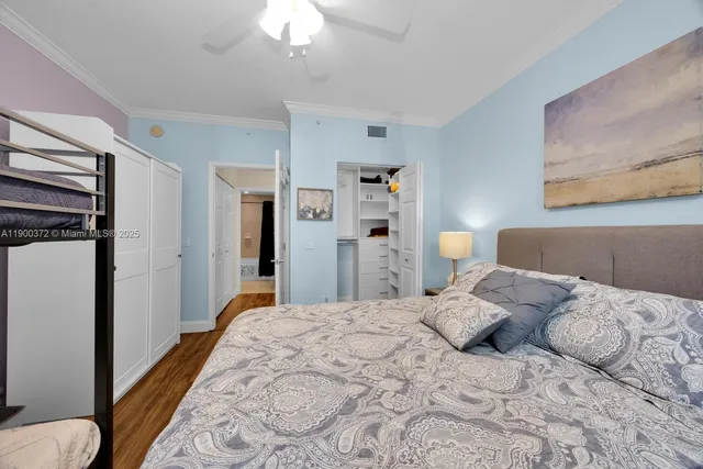 a bedroom with a bed and a chandelier