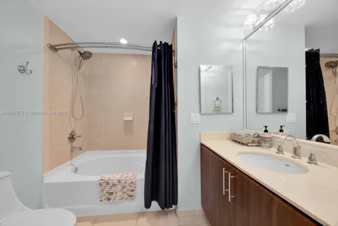 a bathroom with a sink double vanity mirror and a bathtub