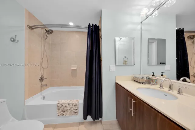 a bathroom with a sink double vanity mirror and a bathtub
