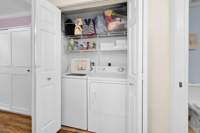 a utility room with dryer washer and a fridge