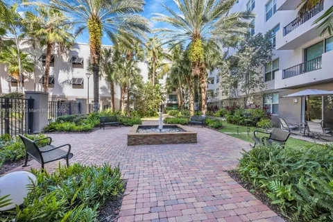 a view of a bench sitting in back yard of a building
