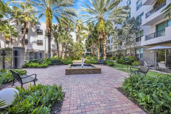 a view of a bench sitting in back yard of a building