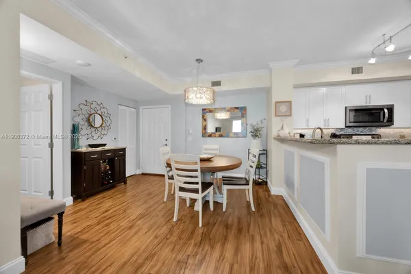 a view of a dining room with furniture and wooden floor