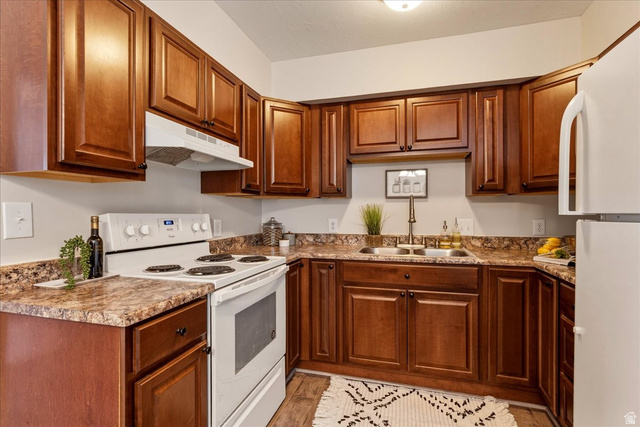 947 Canyon Road, Unit 29 Ogden, UT 84404 - Photo 5 of 19 Kitchen featuring white appliances, wood finish cabinetry, and light wood-style flooring