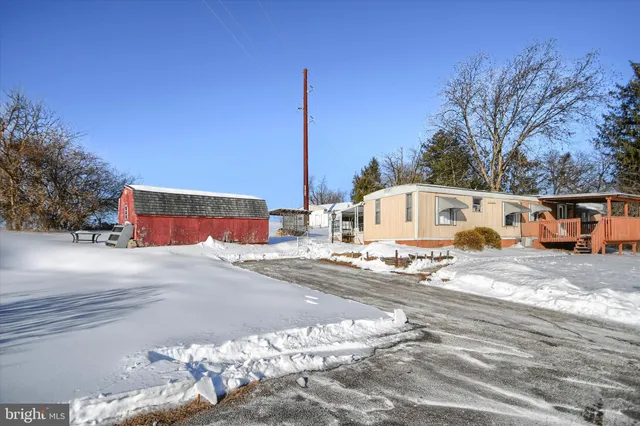 a front view of a house with a road