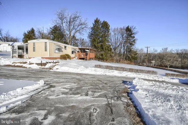a pathway of a house with a yard