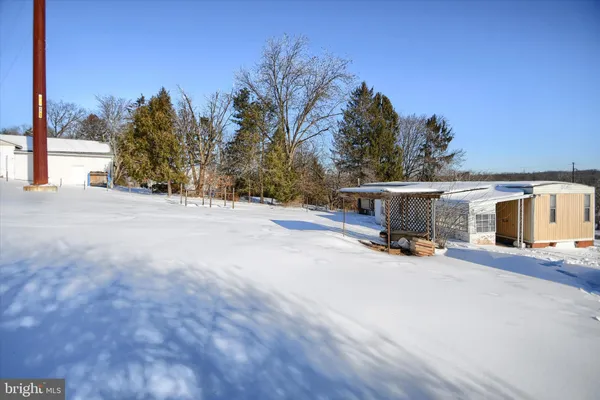 a view of house with a yard