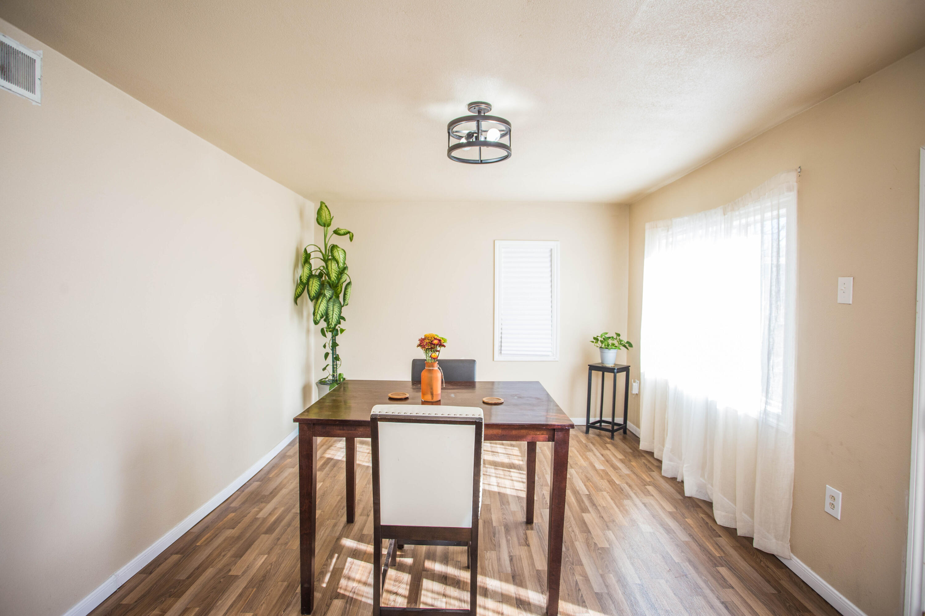 2103 30th Street Lubbock, TX 79411 - Photo 12 of 15 a view of a dining room with furniture window and wooden floor