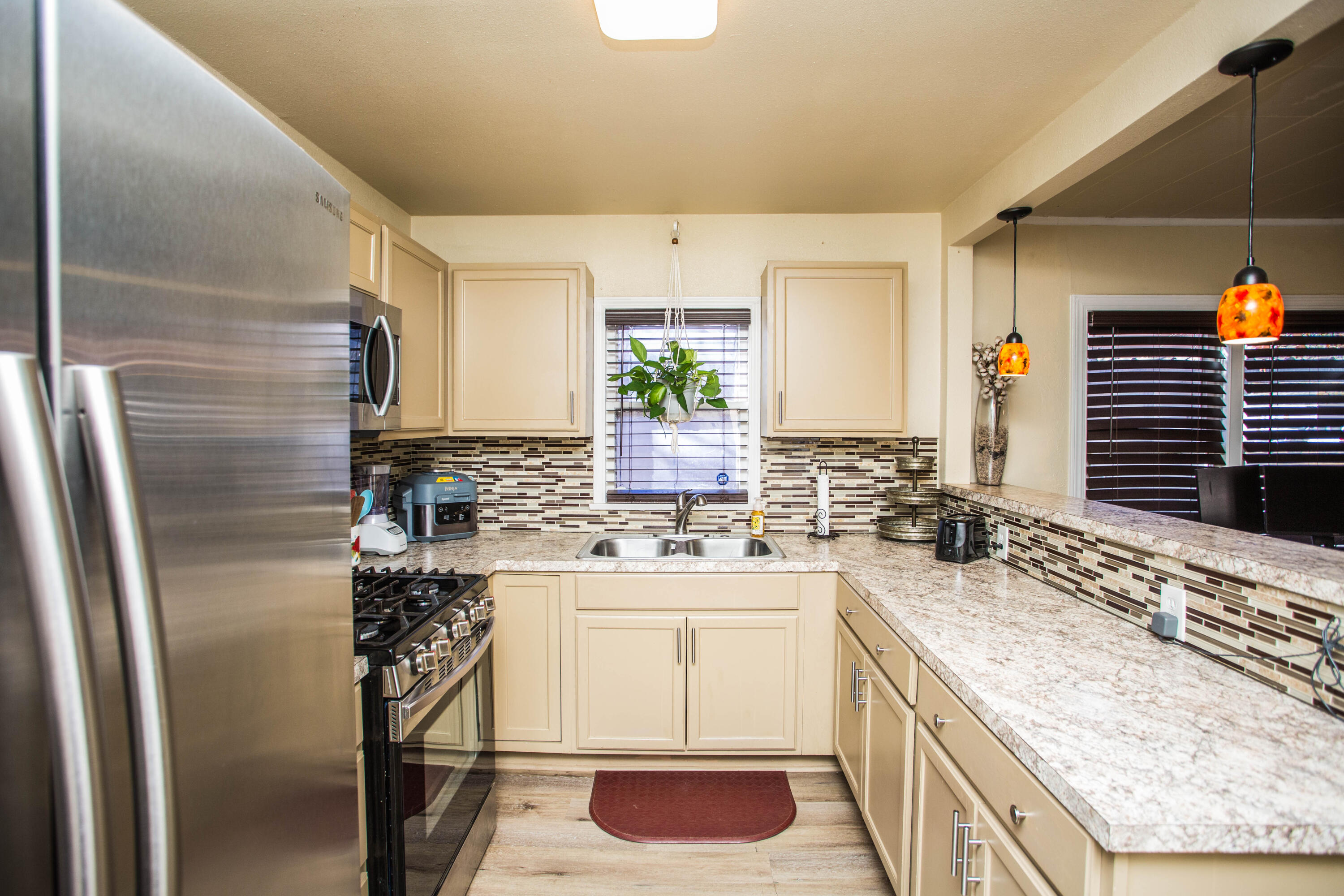 2103 30th Street Lubbock, TX 79411 - Photo 10 of 15 a kitchen with a sink stove and refrigerator