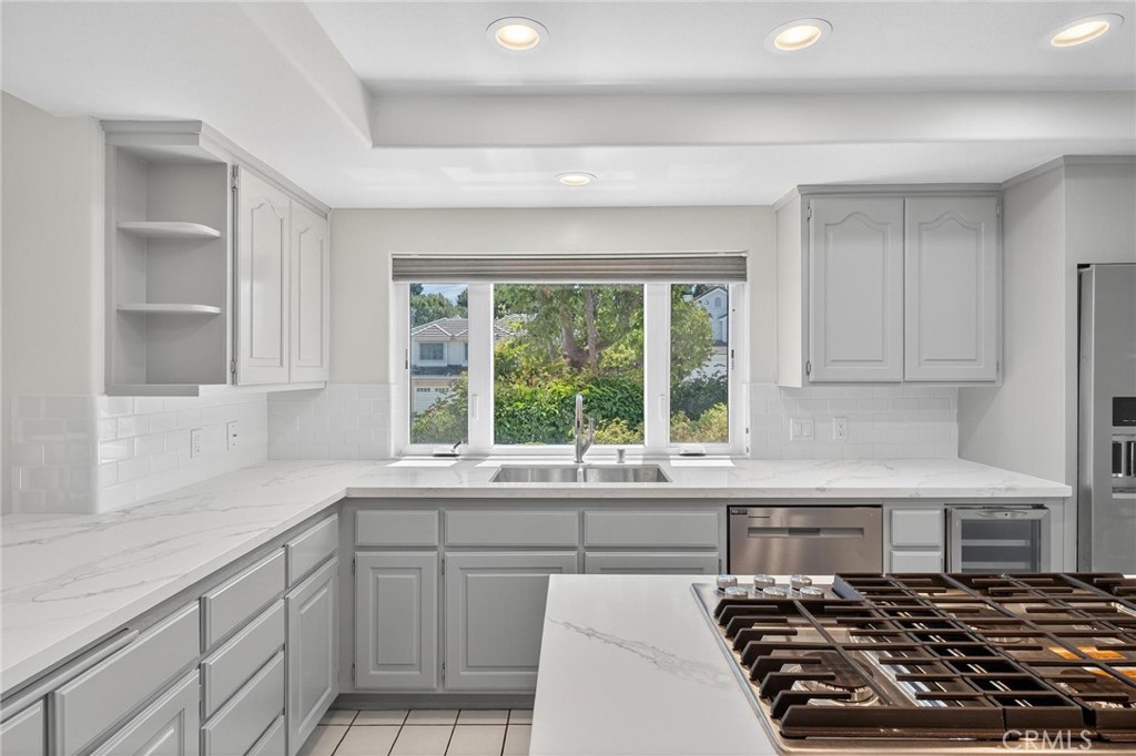 2 Cambridge Manhattan Beach, CA 90266 - Photo 13 of 38 a kitchen with a stove a sink and a window
