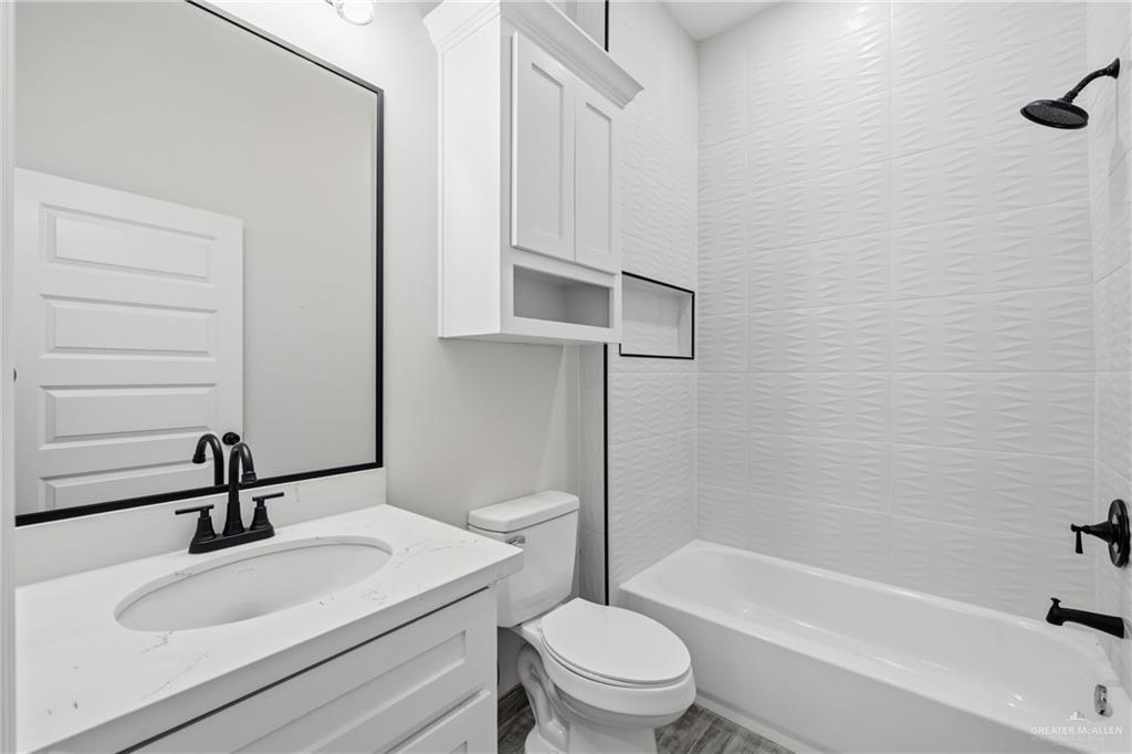 710 West 25th Street Mission, TX 78574 - Photo 14 of 15 a bathroom with a sink a toilet and bathtub
