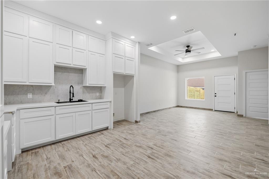 710 West 25th Street Mission, TX 78574 - Photo 5 of 15 a large white kitchen with sink and white cabinets