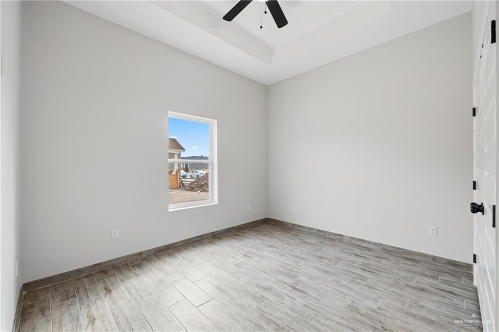 710 West 25th Street Mission, TX 78574 - Photo 9 of 15 an empty room with wooden floor and window