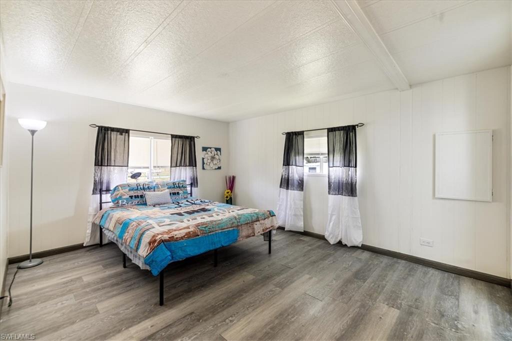 952 Days Lane North Fort Myers, FL 33917 - Photo 12 of 46 a bedroom with a large bed and wooden floor