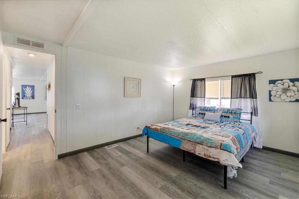 952 Days Lane North Fort Myers, FL 33917 - Photo 13 of 46 a bedroom with a bed and wooden floor