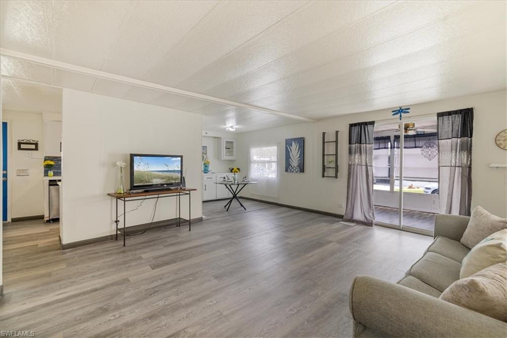 952 Days Lane North Fort Myers, FL 33917 - Photo 20 of 46 a living room with furniture and a flat screen tv