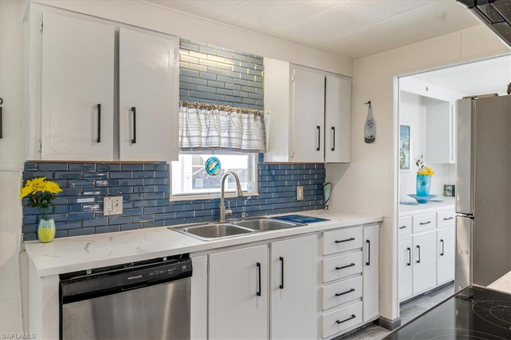952 Days Lane North Fort Myers, FL 33917 - Photo 3 of 46 a kitchen with granite countertop a sink stainless steel appliances and cabinets