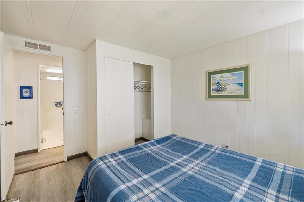 952 Days Lane North Fort Myers, FL 33917 - Photo 10 of 46 a bedroom with a bed and a painting on the wall