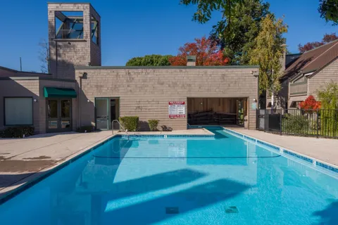 a view of a terrace with a fireplace and potted plants