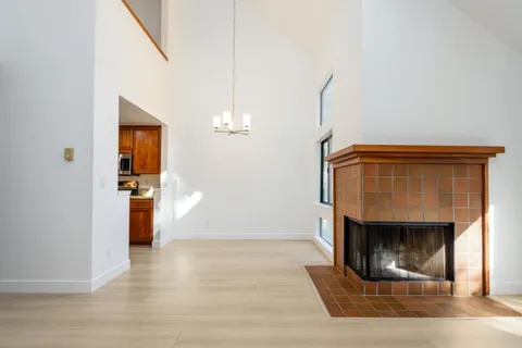 a living room with fireplace and a wooden floor