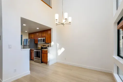 a view of a kitchen with a sink a refrigerator and a window