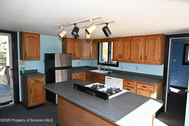 a kitchen with a sink a stove and a refrigerator