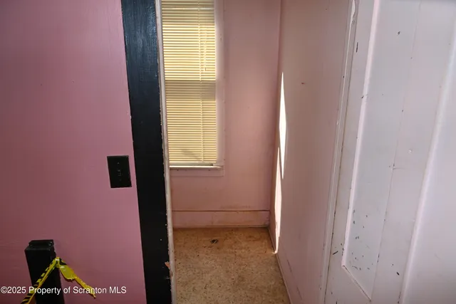 a view of a balcony with wooden floor and fence