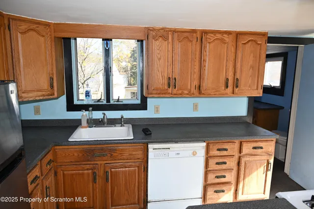 a kitchen with granite countertop a sink and a window