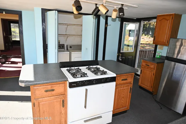 a kitchen with a stove and a refrigerator