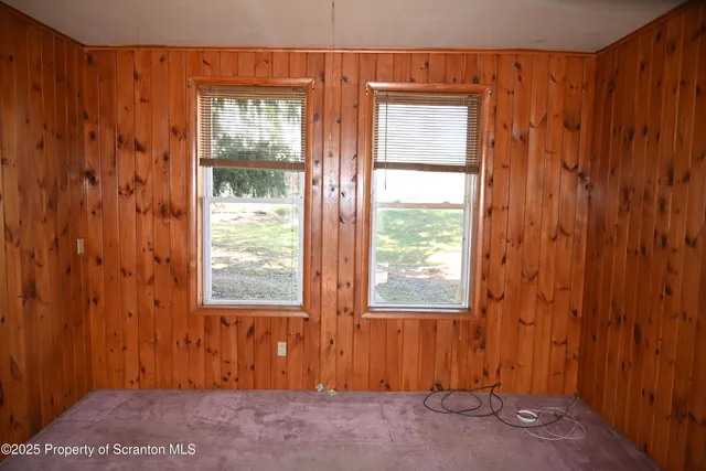 a view of an entrance with wooden floor and a window