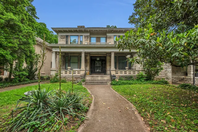 a front view of a house with garden and porch