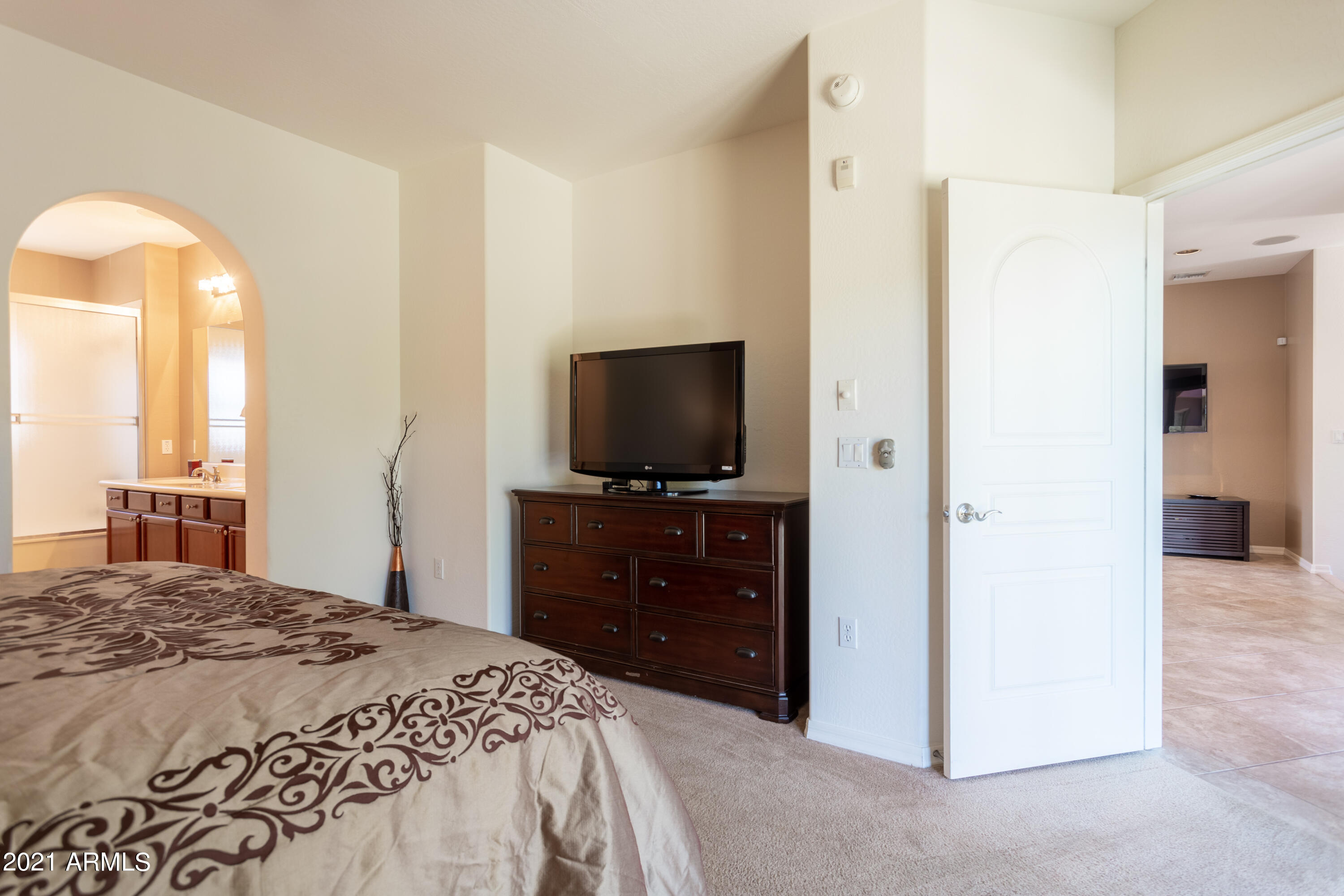 3935 East Rough Rider Road, Unit 1192 Phoenix, AZ 85050 - Photo 11 of 20 a bedroom with a bed and a flat screen tv