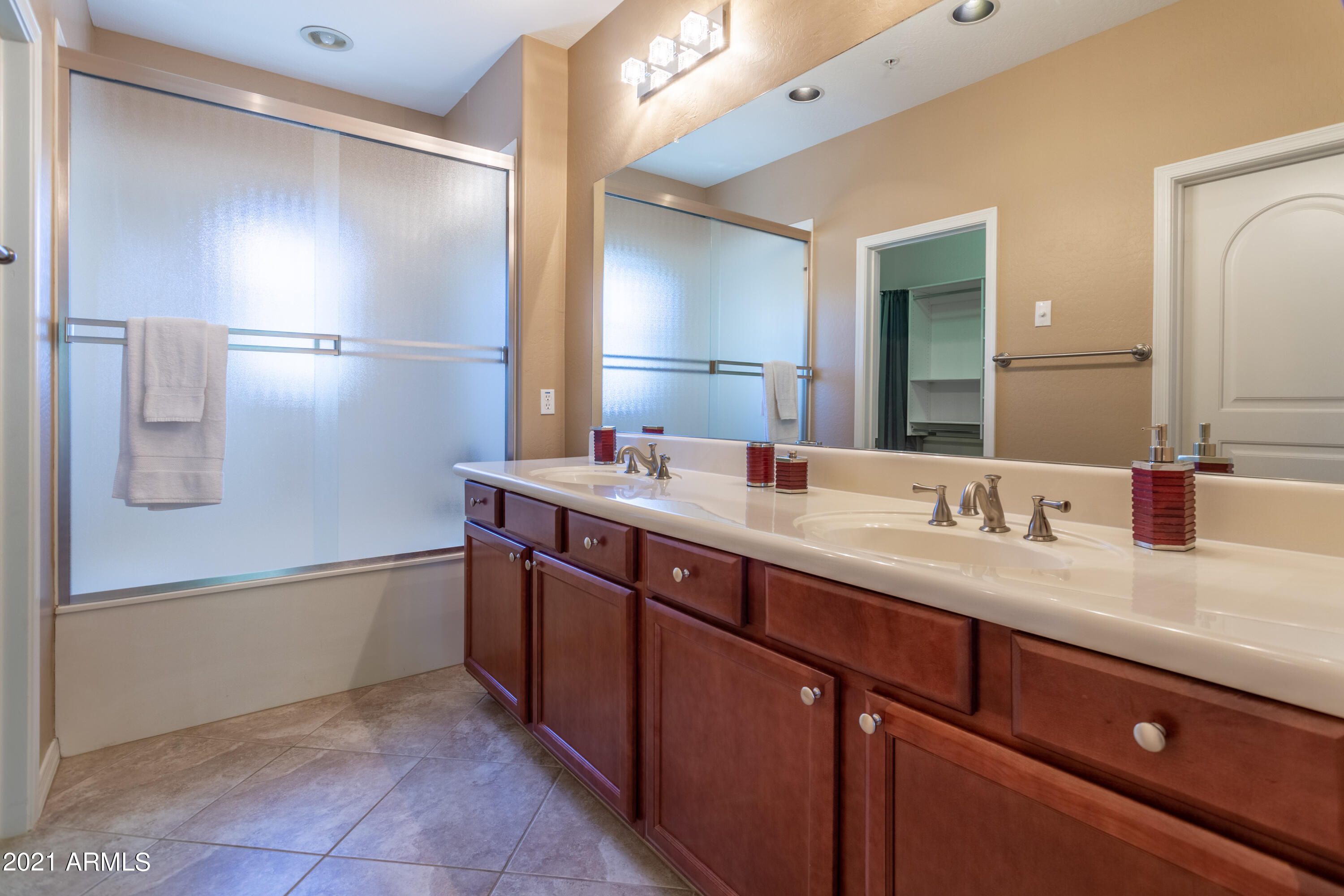 3935 East Rough Rider Road, Unit 1192 Phoenix, AZ 85050 - Photo 12 of 20 a bathroom with a double vanity sink and mirror