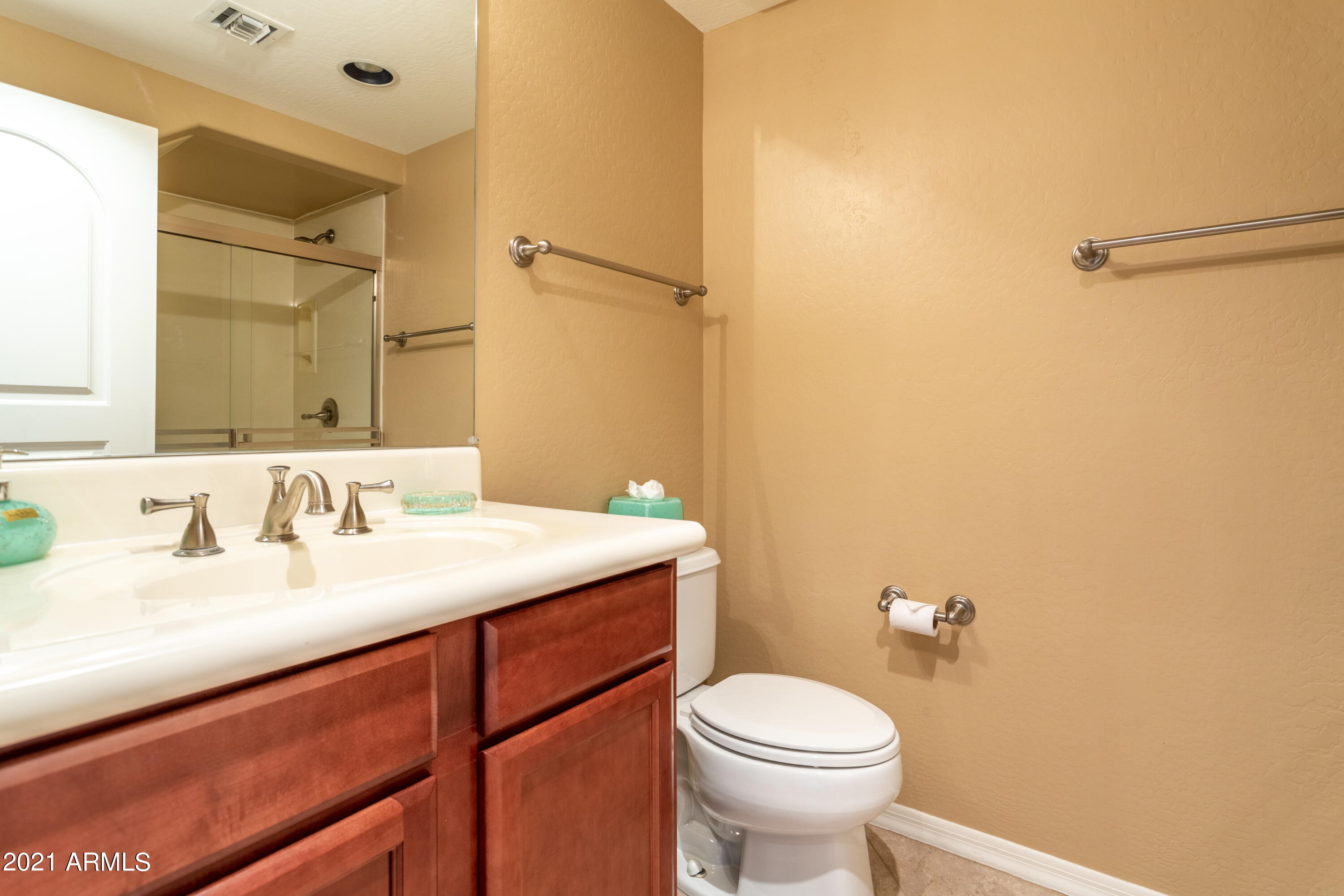 3935 East Rough Rider Road, Unit 1192 Phoenix, AZ 85050 - Photo 14 of 20 a bathroom with a sink a toilet and a mirror