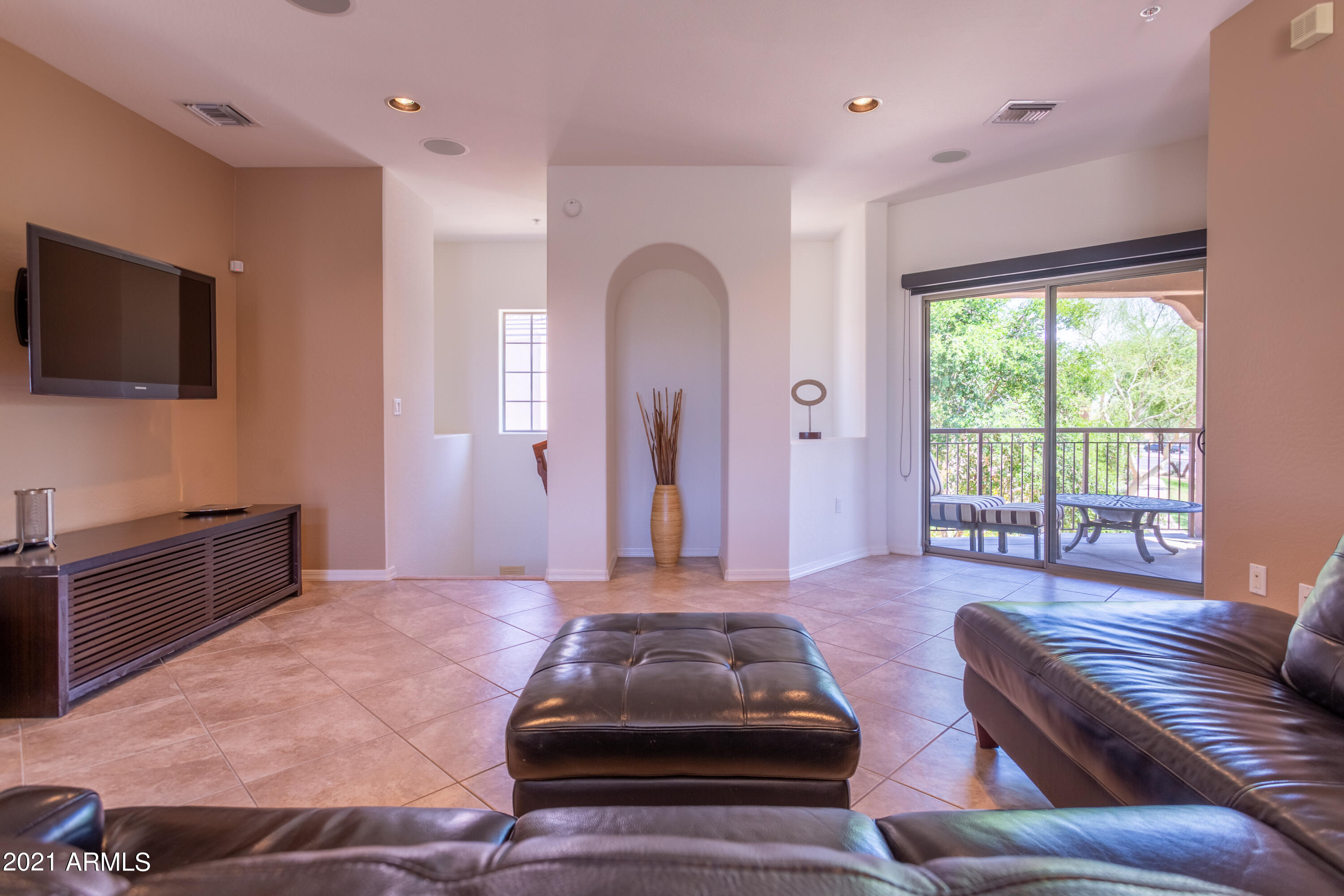 3935 East Rough Rider Road, Unit 1192 Phoenix, AZ 85050 - Photo 8 of 20 a living room with furniture and a flat screen tv
