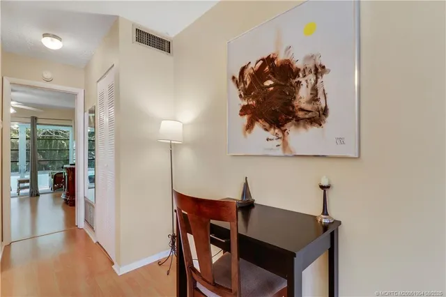 a view of a workspace with furniture and wooden floor