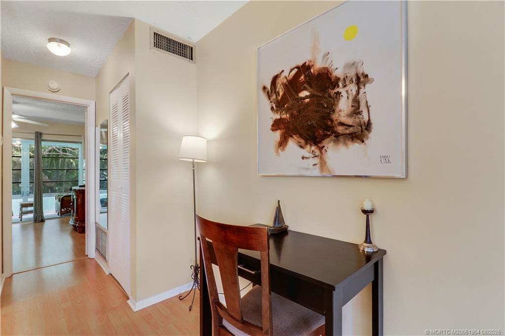 2929 Southeast Ocean Boulevard, Unit 1049 Stuart, FL 34996 - Photo 11 of 31 a view of a workspace with furniture and wooden floor