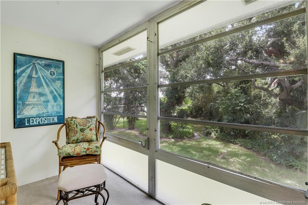 2929 Southeast Ocean Boulevard, Unit 1049 Stuart, FL 34996 - Photo 20 of 31 a room with a large window and a couch