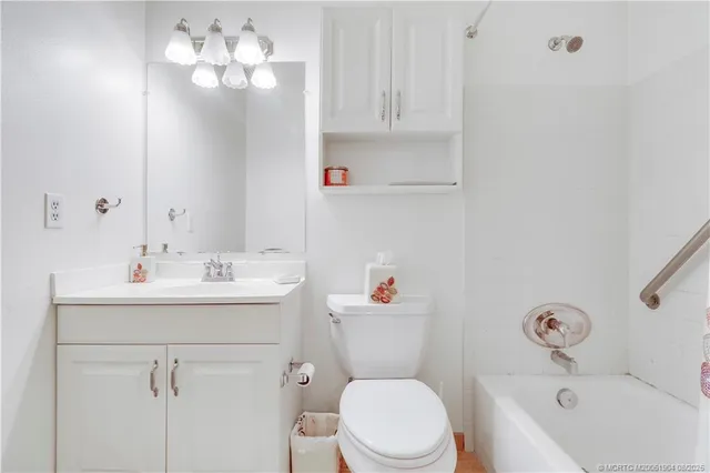 a bathroom with a sink a toilet and shower curtain
