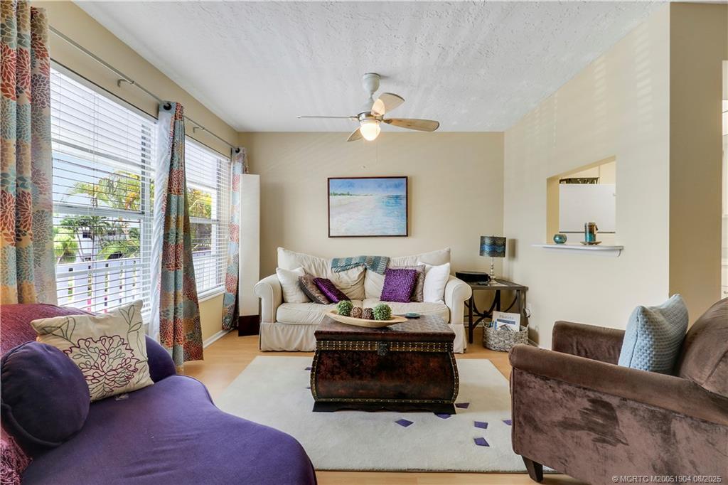 2929 Southeast Ocean Boulevard, Unit 1049 Stuart, FL 34996 - Photo 6 of 31 a living room with furniture and a window