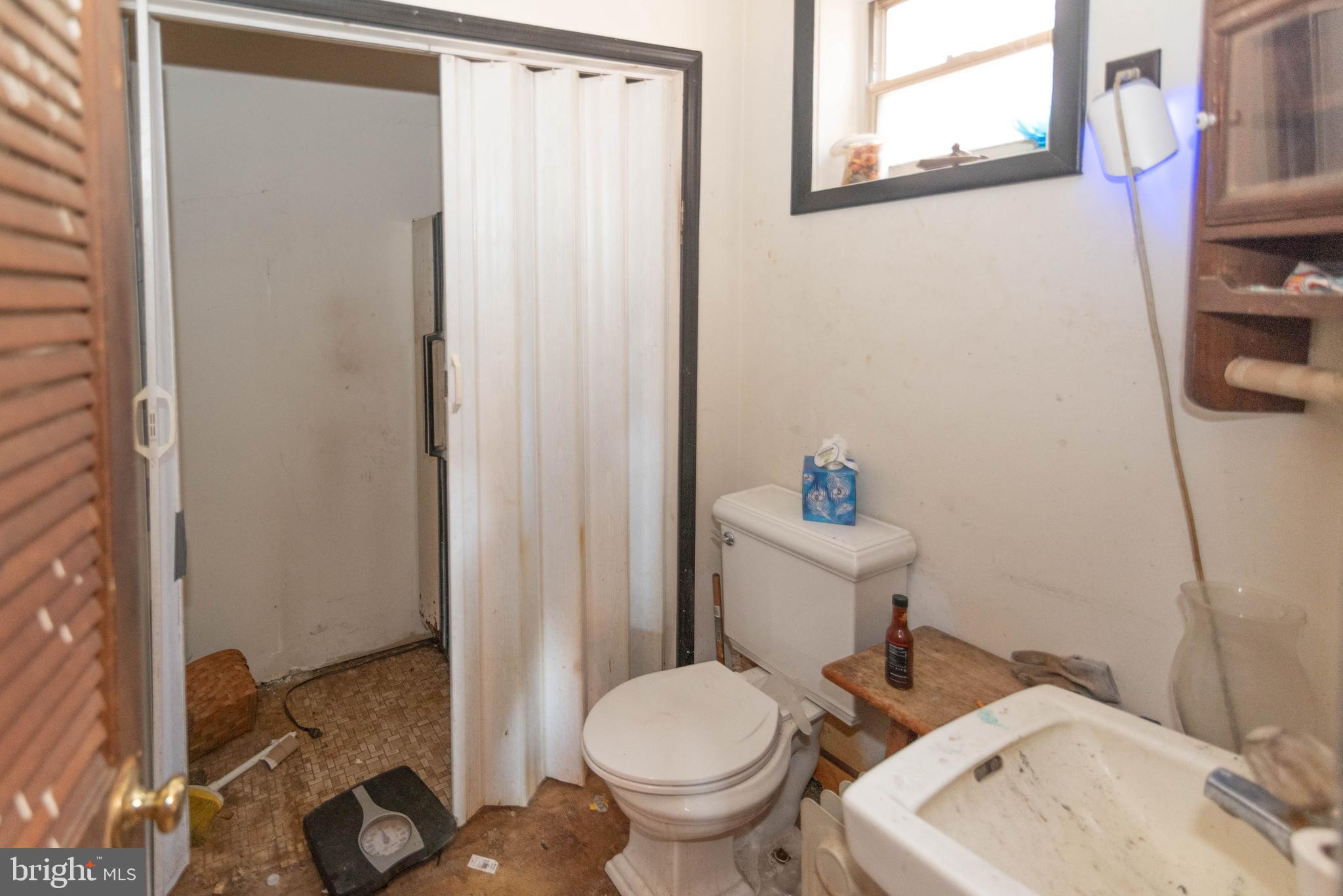 2100 Singerly Road Elkton, MD 21921 - Photo 16 of 67 a white toilet sitting next to a bathroom sink